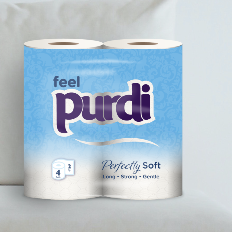 Perfectly Soft toilet roll package sitting on plush sofa